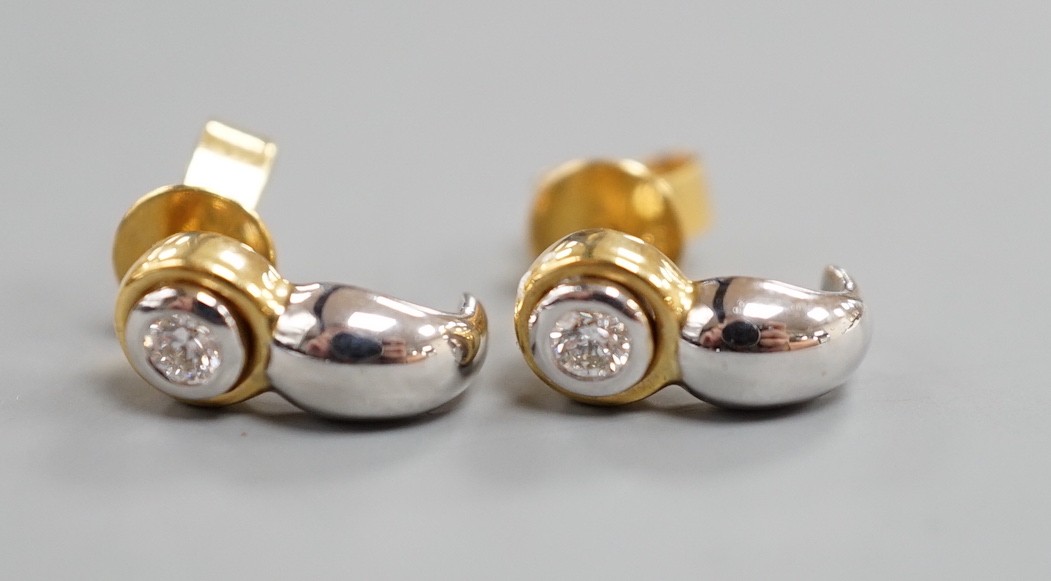 A modern pair of two colour 750 metal and single stone diamond set earrings, 12mm, gross weight 2.9 grams.